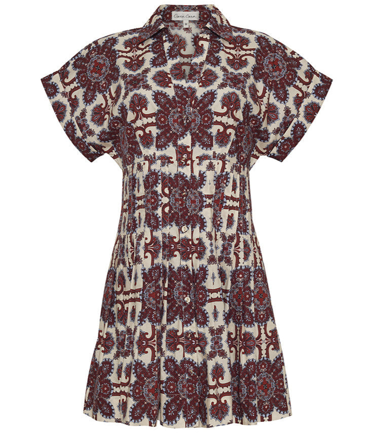 The Cara Cara Nash Mini Dress is a short-sleeve collared mini shirtdress with a brown, maroon, and blue paisley print on cream, featuring a pleated skirt and button front for an ideal fit.