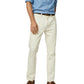 A person wearing a light blue shirt, cream-colored pants, and brown loafers stands against a white background, showcasing a classic style often complemented by Sid Mashburn's Slim Straight Jean, crafted in the USA.