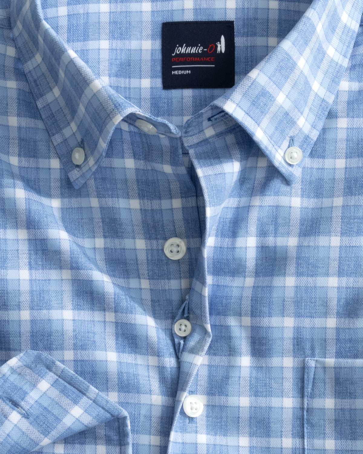 Introducing the Johnnie-O Roosevelt Button Down: a stylish blue and white checkered performance shirt designed with wrinkle-resistant oxford fabric for effortless maintenance, complete with the iconic "johnnie-O" label on the inside collar.