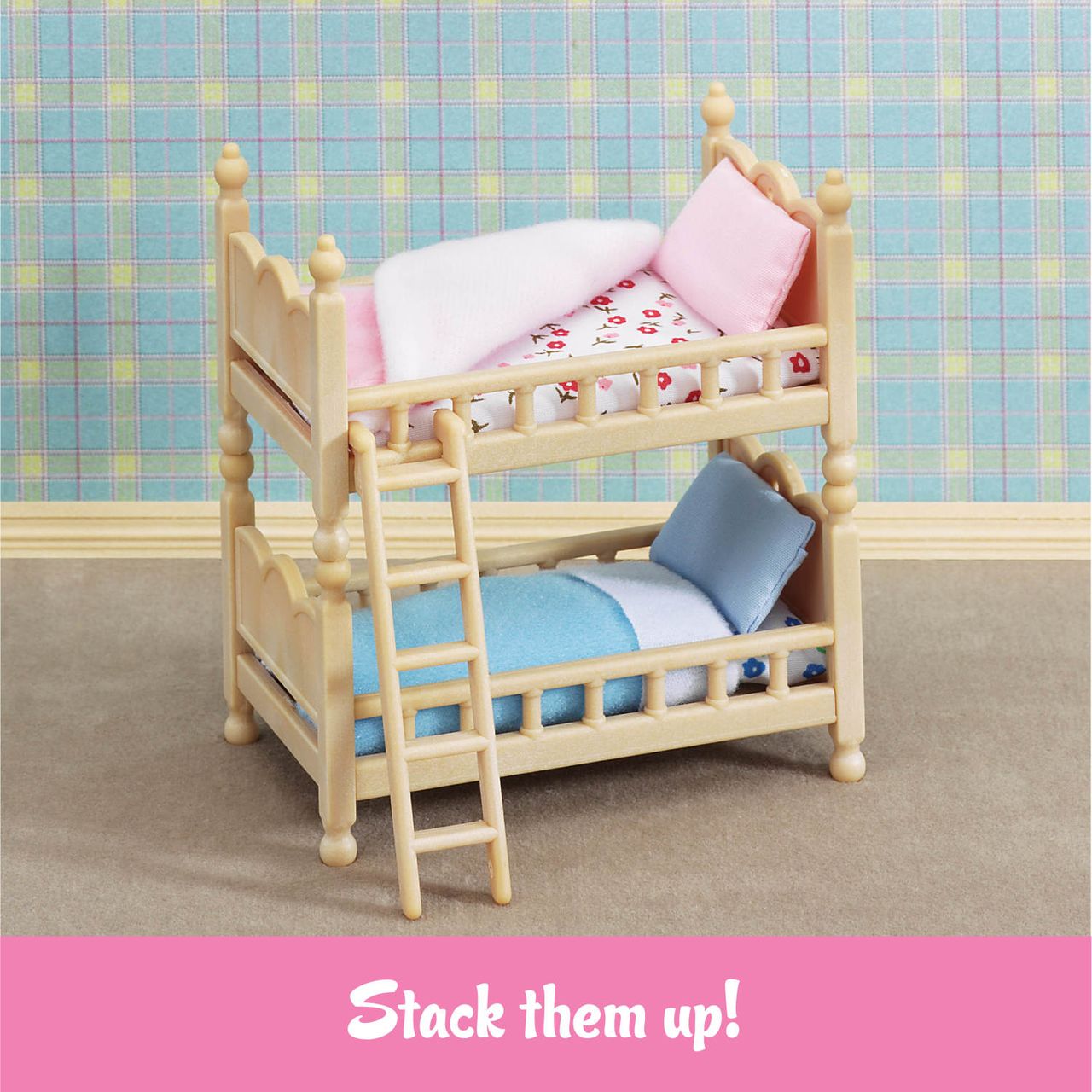Miniature wooden bunk beds with pastel bedding, a ladder, and a plaid wallpaper background—perfect as dollhouse furniture or for Calico Critters. Text at the bottom reads, “Stack them up!” featuring Stack and Play Beds by Calico Critters.