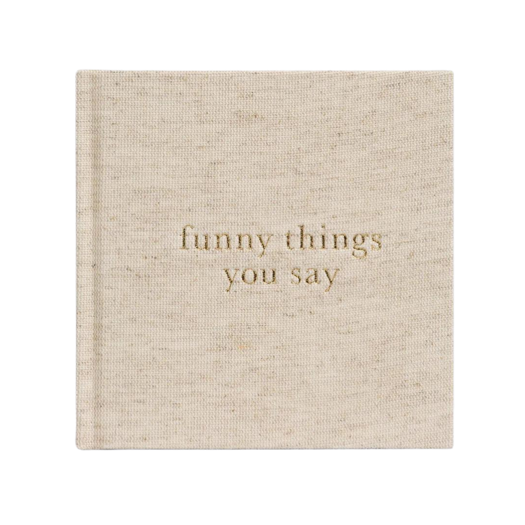 A Write To Me Funny Things You Say Oatmeal journal by Write To Me is titled "funny things you say" in gold letters on the cover, perfect for jotting down memorable quotes from your kids.