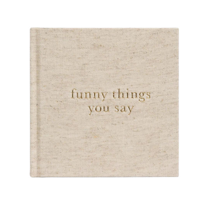 A Write To Me Funny Things You Say Oatmeal journal by Write To Me is titled "funny things you say" in gold letters on the cover, perfect for jotting down memorable quotes from your kids.