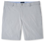 A pair of Peter Millar Surge Performance Shorts, light gray men's shorts with four-way stretch displayed against a white background.