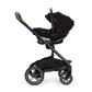 A black Nuna stroller with the Pipa Aire RX Carseat attached, featuring smart security features, a spacious lower storage basket, and four large wheels.