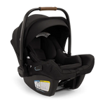 The Nuna Pipa Aire RX Carseat by Nuna is a black, lightweight infant car seat featuring a canopy and handlebar with brown accents. Crafted from machine washable fabrics, the seat includes a label with safety information and visible adjustment mechanisms on the sides. It is also FAA certified, providing peace of mind during travel.