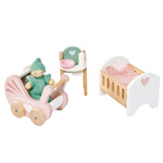 Introducing the Tender Leaf Dolls House Nursery Set by Tender Leaf Toys, a delightful collection perfect for imaginative play. This enchanting set includes a doll accompanied by a pink stroller, a green high chair complete with a bowl and bottle, and a traditional-style cot adorned with a pink blanket. It's ideal for inspiring cozy scenes of care and nurturing fun.