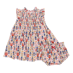 A vibrant Stevie Dress and matching bloomers by Pink Chicken, adorned with a Nutcracker-themed print featuring various Nutcracker characters in a repeated pattern.