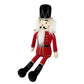 The MON AMI The Nutcracker Shelf Sitter - Large Red, crafted from soft polyester by Mon Ami, showcases a black hat, white hair, and a red uniform while sitting with its legs extended. This plush doll makes perfect holiday decor.