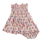 The Pink Chicken Baby Girls Stevie Dress, by Pink Chicken, is a charming children's dress and diaper cover set adorned with a colorful pattern of toy soldier illustrations on a white background.