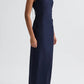 A model wears the TWP Gathered Thoughts Dress, a sleeveless navy blue maxi with a high neck, paired with black sandals, set against a plain white background.