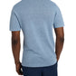 An individual wearing a relaxed fit, light blue Onia Linen Sweater Polo and navy shorts is standing with their back to the camera.