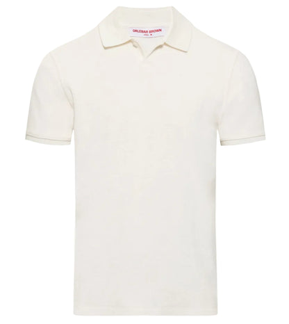 The Orlebar Brown Bruno Towelling Polo is a plain white short-sleeve polo shirt made from organic cotton, featuring a collar and a small inner neck label.