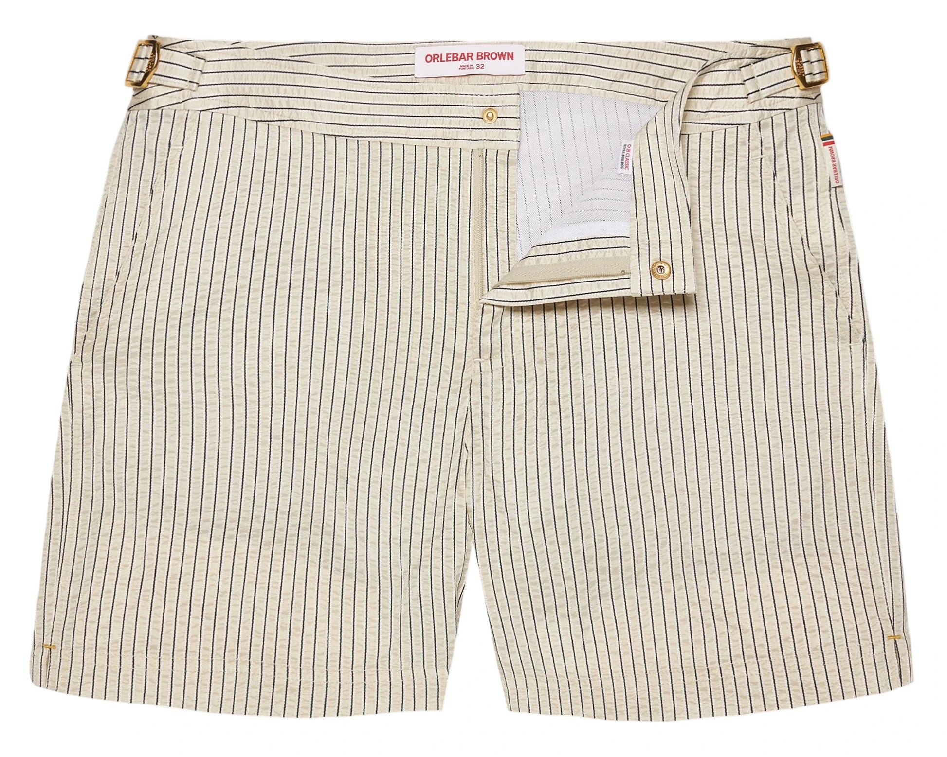 The Orlebar Brown Bulldog Classic Stripe Short features beige and white stripes, signature side-fasteners, a partially open front flap, and a visible waistband label—ideal for those wanting refined swimwear style.