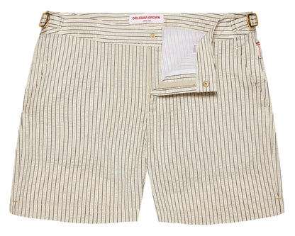 The Orlebar Brown Bulldog Classic Stripe Short features beige and white stripes, signature side-fasteners, a partially open front flap, and a visible waistband label—ideal for those wanting refined swimwear style.