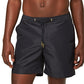 A man wears the Orlebar Brown Bulldog Drawcord Short, featuring a tailored fit and drawstring waist, standing against a plain white background.