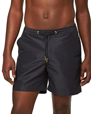 A man wears the Orlebar Brown Bulldog Drawcord Short, featuring a tailored fit and drawstring waist, standing against a plain white background.
