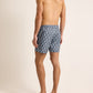 A man faces away, wearing Orlebar Brown Bulldog Drawcord Passetto Swim Trunk in a patterned blue with black slides, set against a plain background.