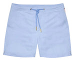 The Orlebar Brown Bulldog Drawcord Swim Short features a light blue, quick-drying fabric, gold-tipped rope-style drawcord, drawstring waist, side pockets, and small side slits at the hem.