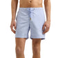 A man wears Orlebar Brown's Bulldog Drawcord Swim Short in light blue, featuring quick-drying fabric and a rope-style drawcord waistband, standing against a plain white background.