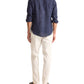 A person stands facing away, wearing the Orlebar Brown Colburn Lino Shirt in navy, paired with off-white pants and black sandals, against a plain white background.