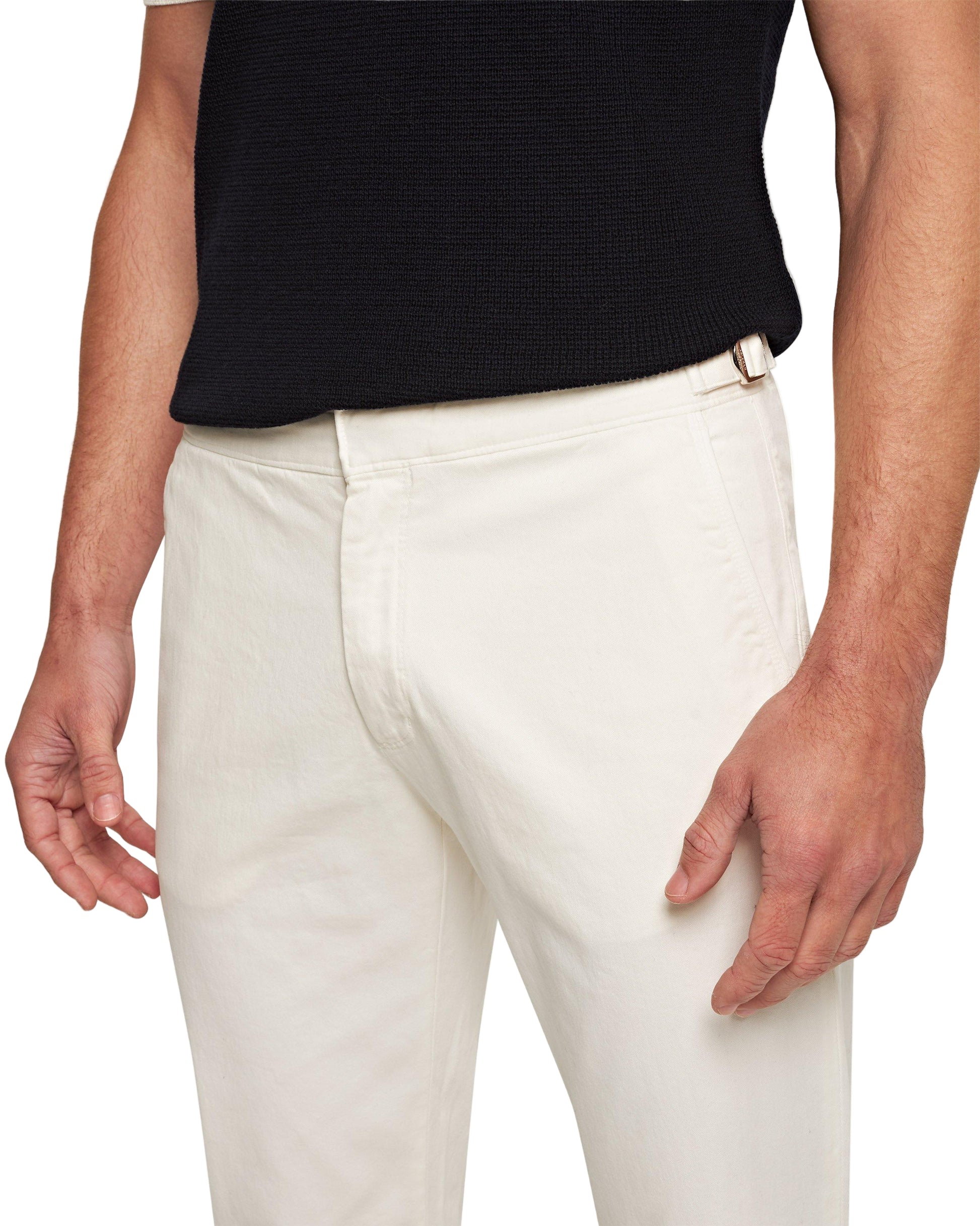 A person wears a black short-sleeve shirt and Orlebar Brown Fallon Stretch-Cotton Pant in off-white, shown from mid-torso to thighs, with arms relaxed at their sides.