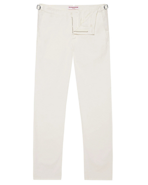 The Orlebar Brown Fallon Stretch-Cotton Pant, in off-white with a tailored fit, adjustable side tabs, and a concealed front closure, is shown laid flat on a white background.