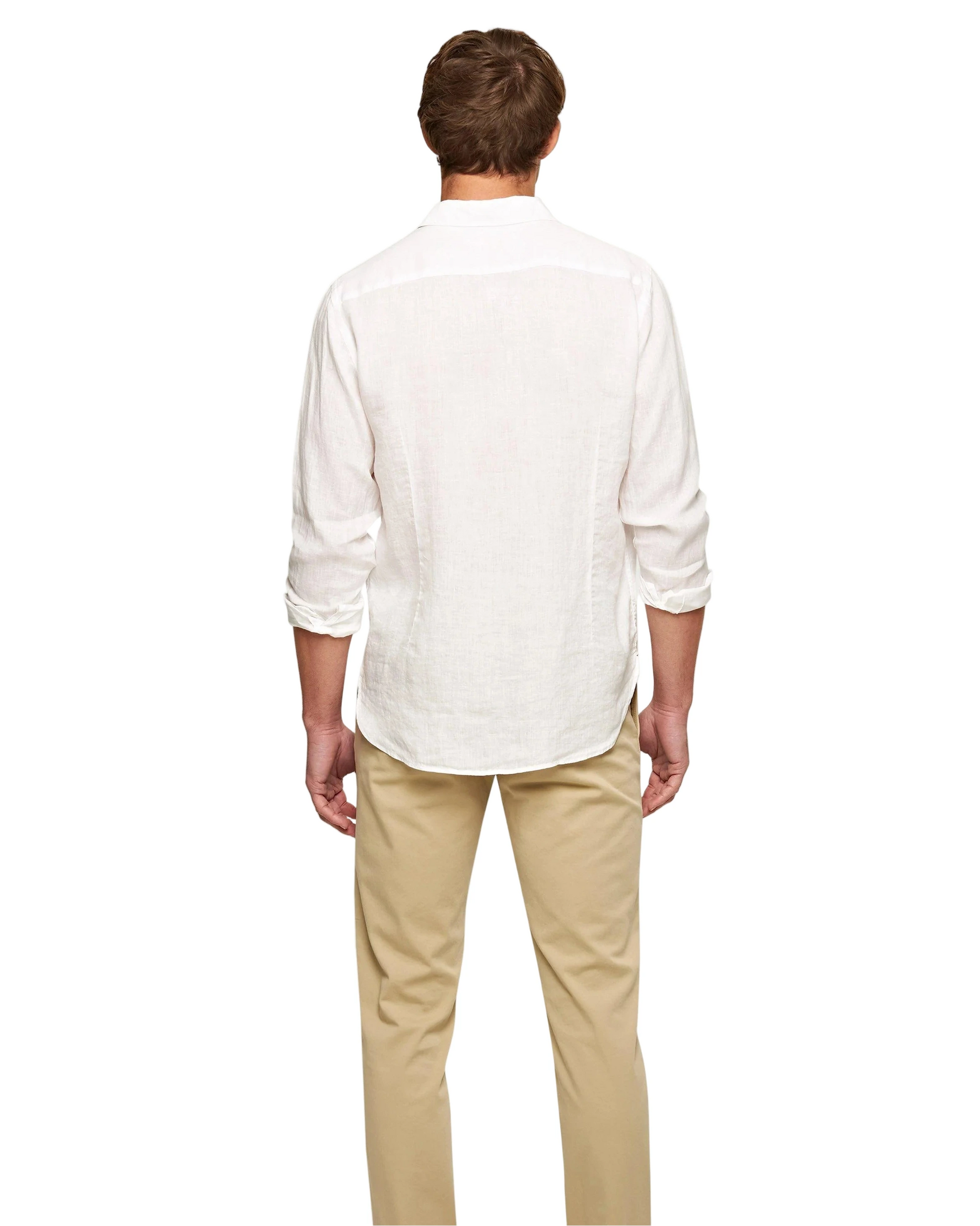 A man faces away from the camera in an Orlebar Brown Giles II Linen Shirt and beige pants—a refined, easy look for warm weather—set against a plain white background.