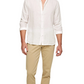 A man wears the Orlebar Brown Giles II Linen Shirt in white with beige pants, standing against a plain white background—an ideal warm-weather outfit.