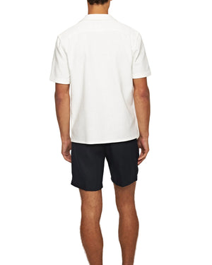 A person faces away, wearing the Orlebar Brown Maitan Open Weave Shirt with black shorts against a plain white background.