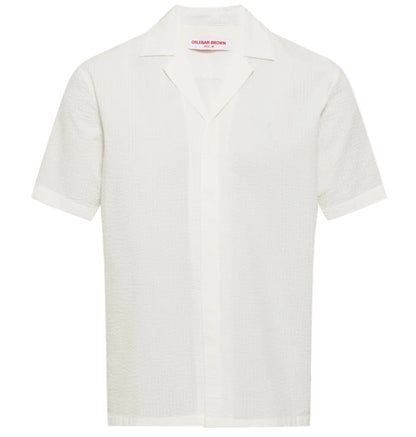 The Orlebar Brown Maitan Seersucker Woven Shirt is a white, relaxed-fit cotton shirt with short sleeves, a Capri collar, and a subtle textured pattern, shown against a plain background.