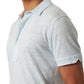 A person in the Orlebar Brown Sebastian Linen Polo in light blue, shown from shoulders to mid-torso and facing slightly left.