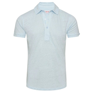 The Orlebar Brown Sebastian Linen Polo, shown on a plain white background, features a light blue color, tailored fit, short sleeves, a collar, and a three-button placket.