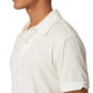 A person wearing a tailored fit, white Terry Polo by Orlebar Brown, shown from the side with only their head and upper torso visible.