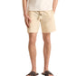 A person wears the Orlebar Brown Sonoran Short Seersucker Stripe with an elasticated waistband, a cream t-shirt, and brown sandals, standing against a plain background.