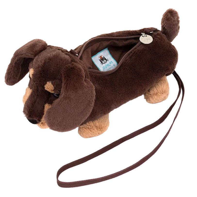 The Jellycat Otto Sausage Dog Shoulder Bag is a plush, brown dachshund-shaped purse with a zipper top and matching strap—an adorable accessory for city strolls.