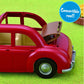 A red Calico Critters Family Cruising Car with a folding convertible roof is pictured on green grass, illustrating the roof as it moves back. The playful vehicle is an ideal addition to any Calico Village scene. A blue circle in the corner highlights, “Convertible roof!”.