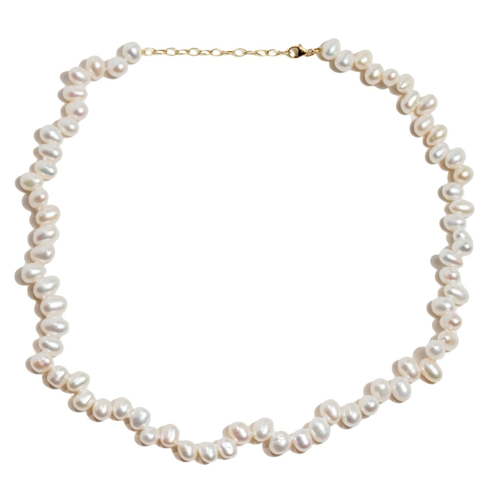 Introducing the Jia Jia Ocean Wild Pearl Necklace: A stunning piece handmade in NYC, featuring uniquely shaped freshwater pearls and a clasp with intricate 14 karat gold detailing. Brought to you by the renowned brand Jia Jia.