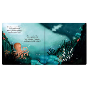 The book "Jellycat The Fearless Octopus" by Jellycat features an open page illustrating a brave octopus swimming gracefully underwater among coral and fish. The accompanying poetic text details the daring octopus as it encounters a shadow resembling a shark, enhancing the intrigue of the story.