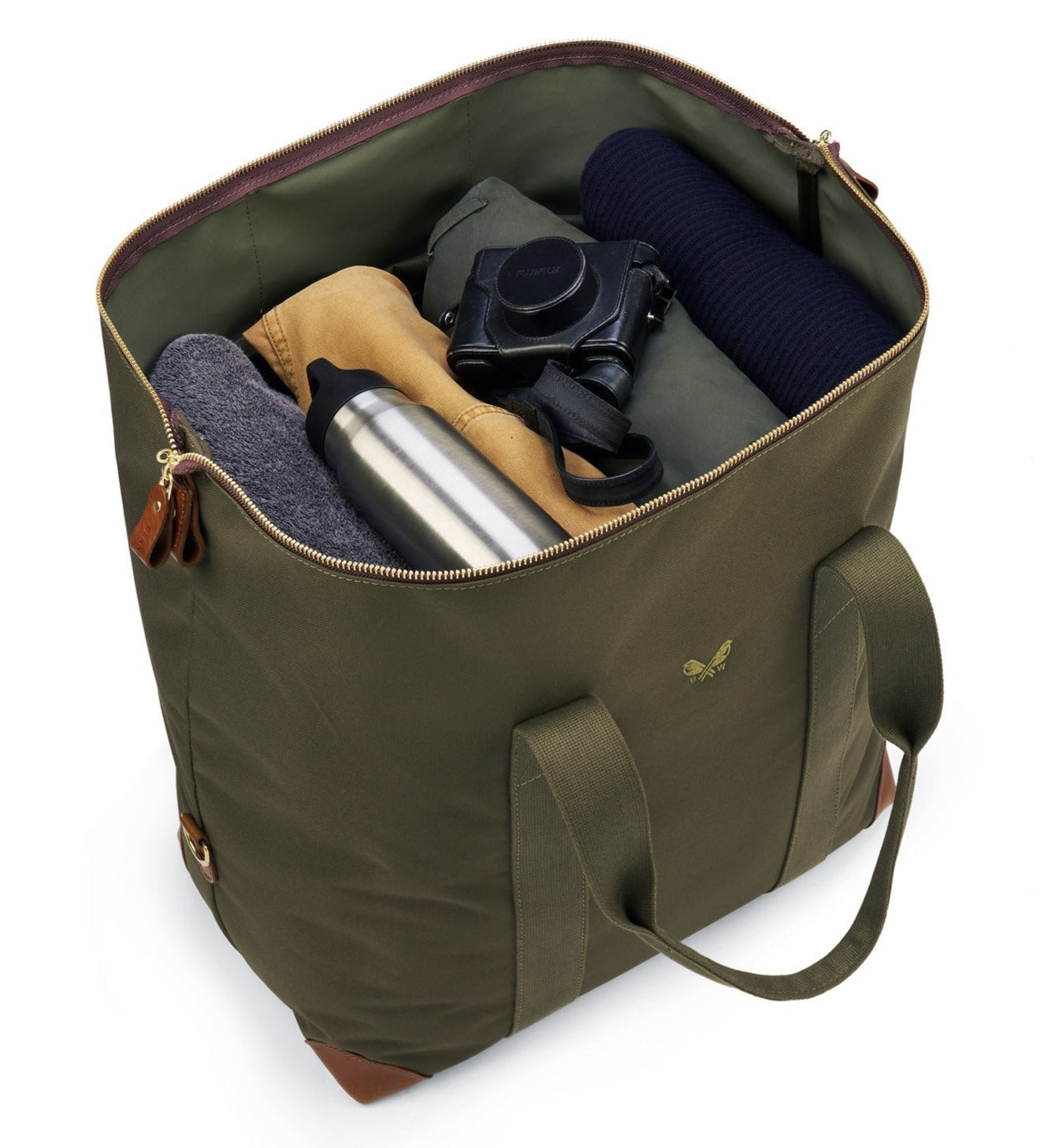 The Bennett Winch Medium Cargo by Bennett Winch is an open green tote bag made from waterproof nylon, containing a rolled-up navy sweater, a camera, gray fabric, a beige item, and a stainless steel bottle.