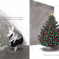 Olivia, the pig, was adorning a small tree with lights and suggesting her friends plug them in first. Next to her was a beautifully decorated Christmas tree crowned with a gleaming star. Text: "Finally the tree was trimmed." Enjoy this festive moment in the board book edition of "Olivia Helps with Christmas" by Simon & Schuster.