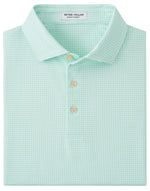 The Peter Millar Orbit Performance Jersey Polo is a folded light green patterned shirt with a collar and three buttons, designed for summer comfort with UPF 50+ protection.