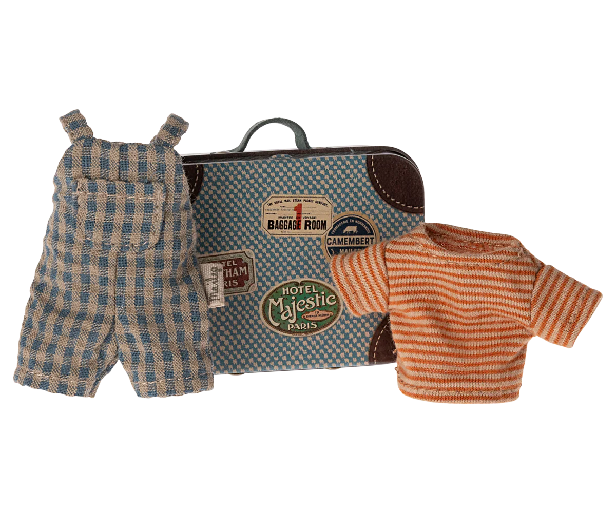 A small metal suitcase featuring travel stickers, a plaid overall, and a striped shirt are displayed together as part of the Maileg Overalls & Shirt in Suitcase set for Big Brother Mouse.