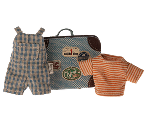 A small metal suitcase featuring travel stickers, a plaid overall, and a striped shirt are displayed together as part of the Maileg Overalls & Shirt in Suitcase set for Big Brother Mouse.