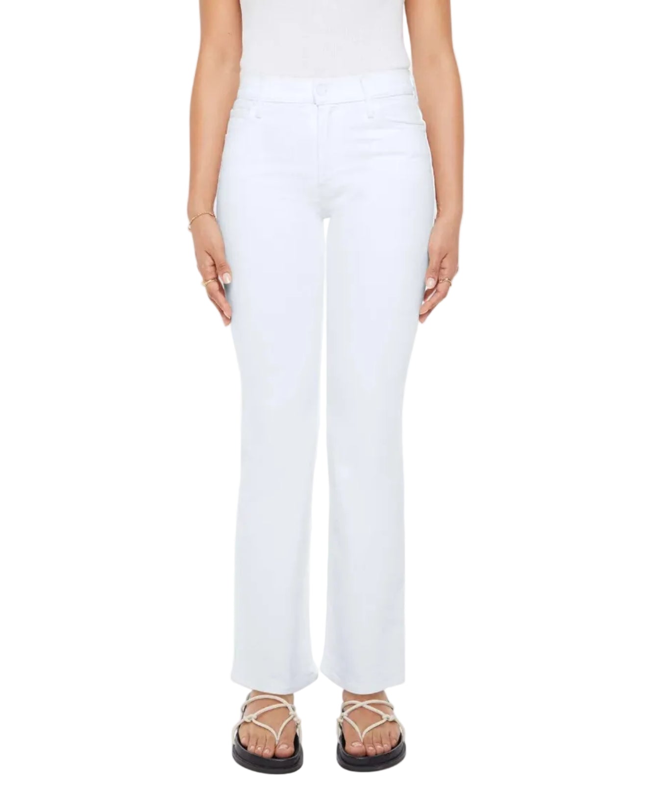 A person wearing Mother’s Petites Lil Kick It white high-rise straight leg jeans, a sleeveless white top, flat sandals, and minimal jewelry stands against a plain background.