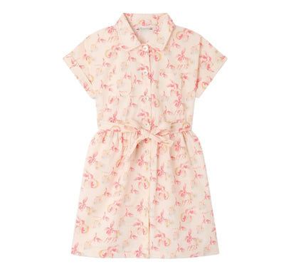The Girls’ Gisele Dress by Bonpoint is a short-sleeved, collared, button-down shirt dress crafted from organic cotton with a pink and yellow floral print and a matching waist tie, shown against a white background.