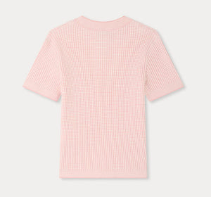 The Girls’ Melie Sweater by Bonpoint is a light pink, short-sleeve knit top featuring a waffled texture and ribbed pattern, displayed flat from the back on a plain white background.