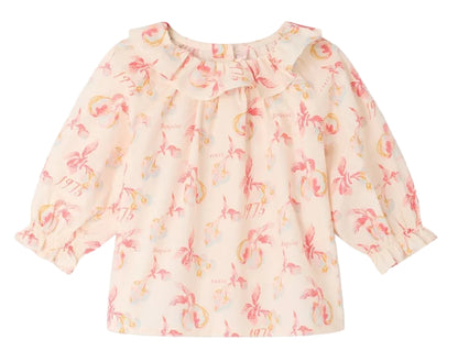 Introducing the Baby Girls’ Dolci Blouse by Bonpoint—this long-sleeved cream blouse features a cheerful pink and yellow tropical floral print, a ruffled neckline, and elasticized cuffs. Made from soft organic cotton, this charming blouse is specially designed for children and perfect for any occasion.