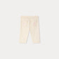 Back view of the Bonpoint Baby Girls’ Luciole Pant in a cream hue, featuring an elastic waistband and two rear pockets, one adorned with a pink basketball and star design. Crafted from cotton-rich fabric for comfort, these organic toddler pants are both stylish and gentle on delicate skin.
