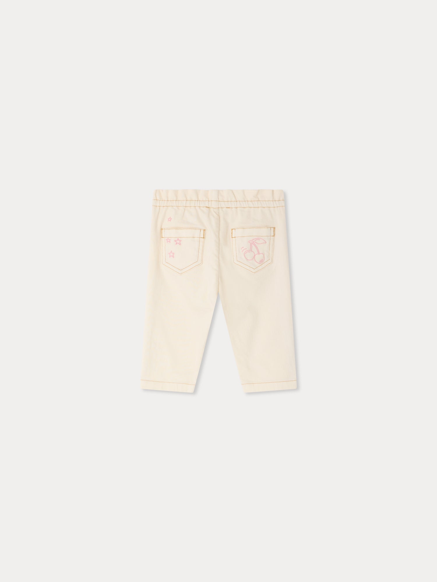 Back view of the Bonpoint Baby Girls’ Luciole Pant in a cream hue, featuring an elastic waistband and two rear pockets, one adorned with a pink basketball and star design. Crafted from cotton-rich fabric for comfort, these organic toddler pants are both stylish and gentle on delicate skin.