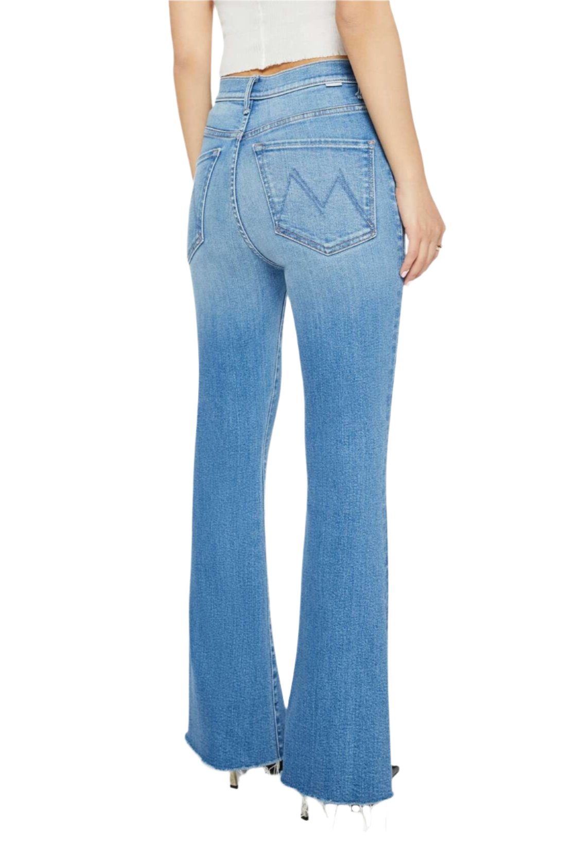 A person is wearing the Mother Denim Petites Lil High Waisted Weekender Fray jeans in light blue, featuring back pocket stitching shaped like the letter “M,” paired with a white top.